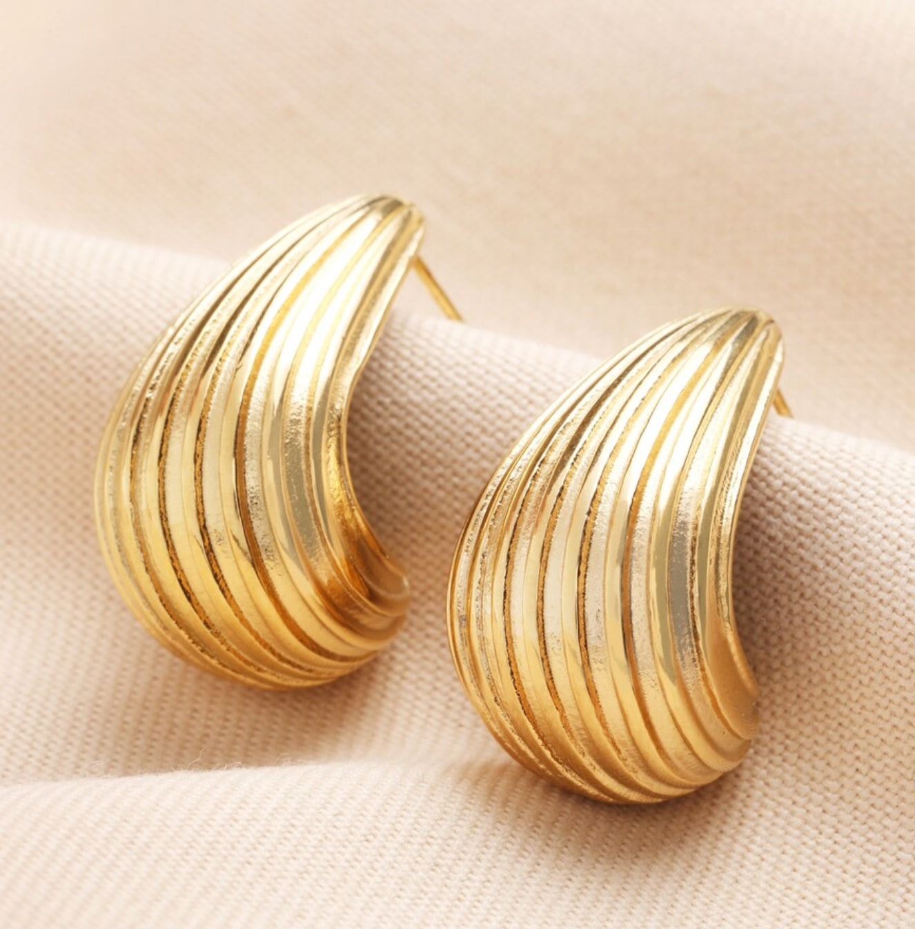 Ridged teardrop half hoop gold earrings