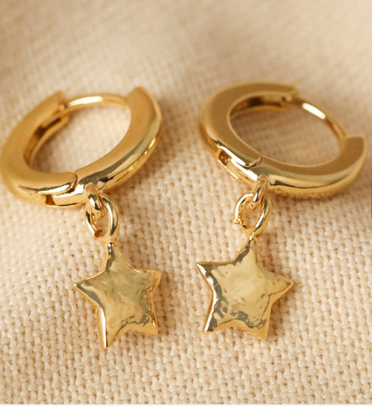 Star charm huggie hoop earrings in gold