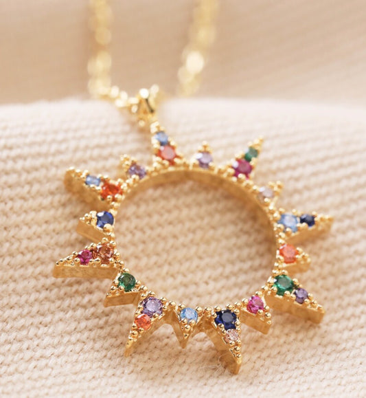 Rainbow crystal sunburst pendant necklace in gold